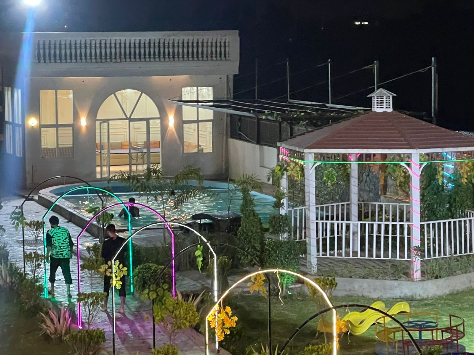 Farmhouse night view with gazebo and pool
